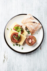 Sandwich with cheese and tomatoes. Bright wooden background. Top view. Copy space.