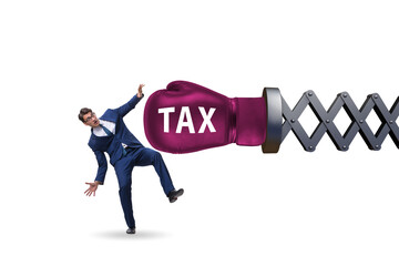 Tax concept with businessman being hit by boxing glove