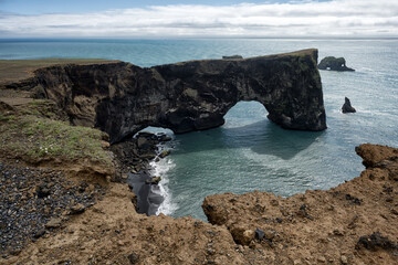 Dyrholaey. Beautiful vulcanic island in the ocean. Iceland.