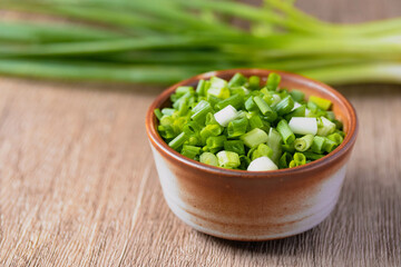 Sliced spring onions in a ceramic cup