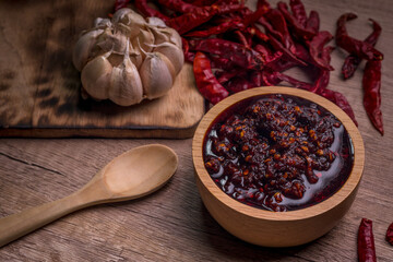 Thai spicy chili paste in a wooden cup (nampnikpao)