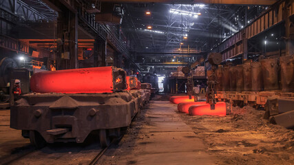 Hot red steel slabs in iron foundry workshop.
