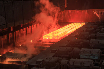 Hot red steel billet on rolling mill. - obrazy, fototapety, plakaty