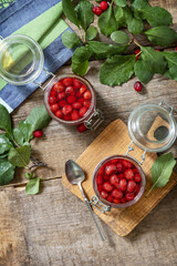 Homemade dogwood jam on a wooden background. Organic jam, healthy food. View from above. Copy space.