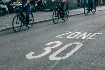 Fototapeta na wymiar speed limit sign on street, bicycles on road at area of zone 30 speed limit