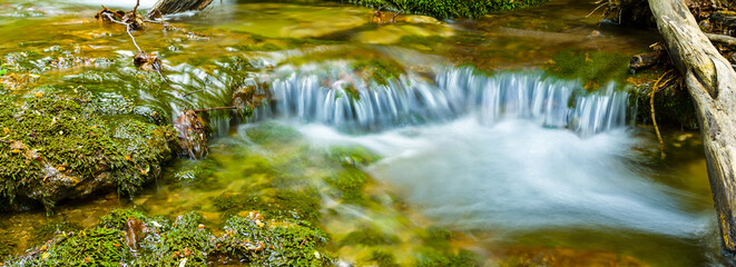 closeup small waterfall on mountain river