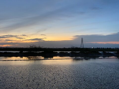 Sunset Behind Transmission Lines And A Salt Pan In Tuticorin, Tamil Nadu, India