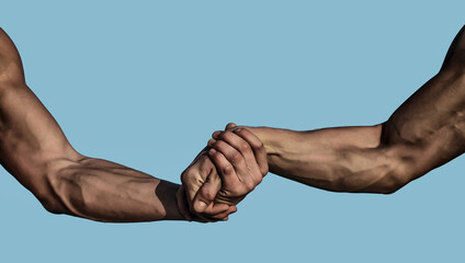 Helping hand, support. Close up help hand. Two hands, helping arm of a friends, teamwork. Rescue, helping gesture or hands. Strong hold. Handshake, arms, friendship and teamwork. Muscular men arms.