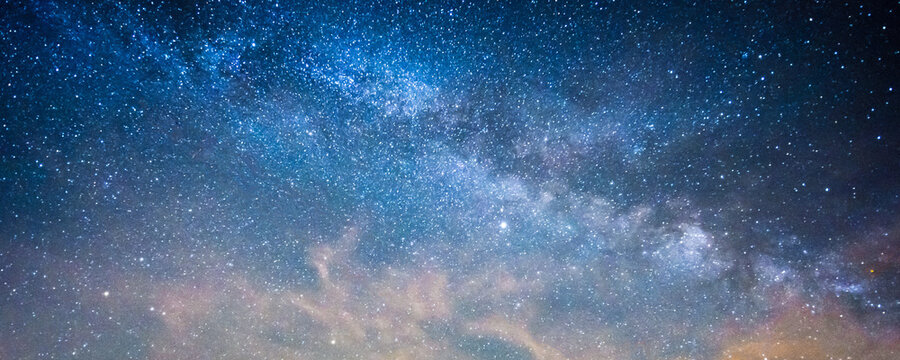 Milky way panorama banner background with blue and purple colors 