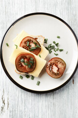 Sandwich with cheese and tomatoes. Bright wooden background. Top view. Copy space.