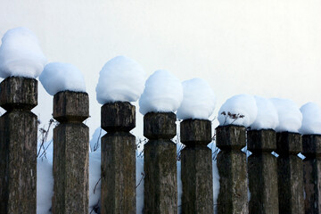 Old wooden fence with snow