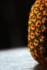 Closeup pineaple skin in a black background