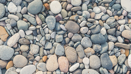 Shingle beach. Soft-colored dry pebbles and stones. Wallpaper idea. High quality photo