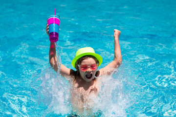 Child drinking coctail in the pool. Little child boy in swimming pool. Kids swim on summer vacation. Beach sea and water fun. Summer kids cocktail.