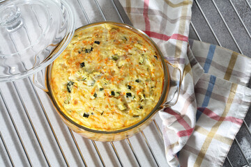 Homemade zucchini, carrots and rice casserole in a glass saucepan