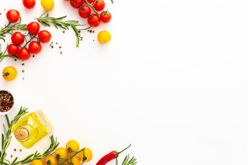 Yellow and red tomatoes, hot peppers, rosemary and spices on a white background, food background, top view, copy space