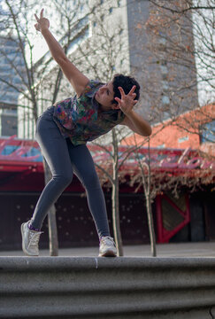 low angle shot of a female artist doing physical movements of butoh dance