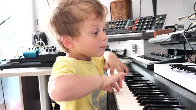 young boy playing electric piano