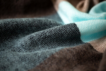 Knitted surface of woolen things as a background. Close-up soft fabric knitted patterns texture. Warm winter clothing. Background textile surface with copy space for text. Men's fashion. blue and gray