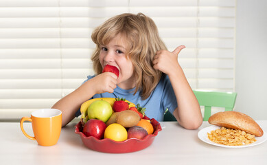 Child with strawberry, summer fruits. Child eating meal. Healthy nutrition for children. Cute boy enjoy eating for morning breakfast with appetite. Hungry child eat tasty fruits and vegetables.