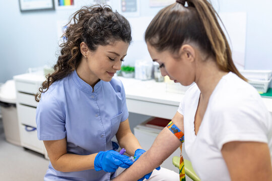 Medical Technologist Doing A Blood Draw Services For Patient. Lab Assistant With Sterile Rubber Gloves Taking Blood Sample From Patient.