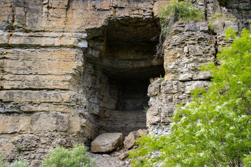 Entrance of a cave in a abandoned rock quarry