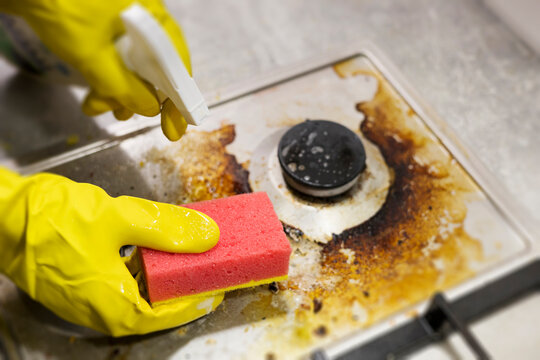 dirty kitchen stove, empty and full bottles of detergents around.