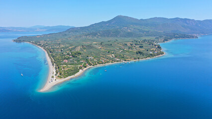 Obraz premium Aerial drone photo of tropical exotic volcanic island complex of Lihadonisia forming a blue lagoon and small islet of Monolia with turquoise clear organised beach, north Evia island, Greece