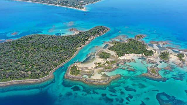 Aerial drone photo of tropical exotic volcanic island complex of Lihadonisia  forming a blue lagoon and small islet of Monolia with turquoise clear organised beach, north Evia island, Greece
