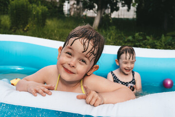 Smiling happy girl in swimming pool. Summer time.