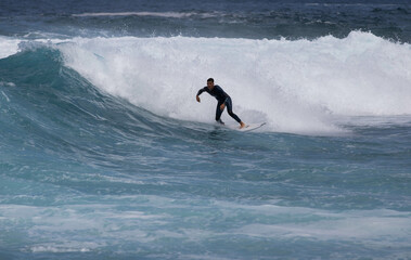 PUERTO DE SANTIAGO, TENERIFE - JUNE 2022: surfer riding the waves in Tenerife