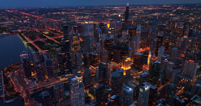 Night lights of glamorous Chicago city, Illinois, USA. Sparkling panorama of vibrant lively metropolis from aerial perspective.