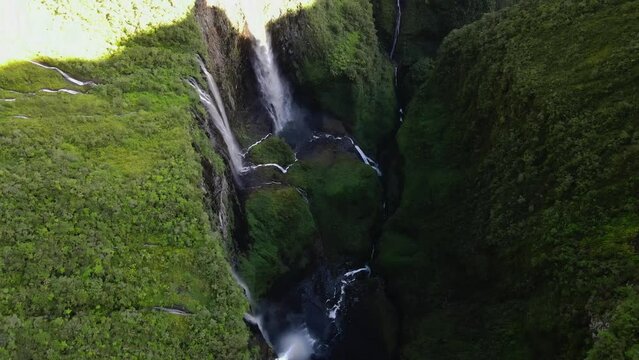 Top-down drone footage of the Trou de Fer waterfalls at the Reunion island with cliffs and jungle.