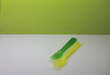 green and yellow forks on a white and green background