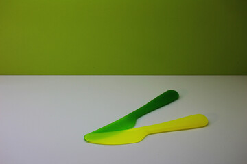 green and yellow knives on a white and green background