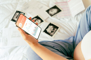 Pregnancy app. Mobile pregnancy online maternity application. Pregnant mother using phone. Pregnancy, medicine, pharmaceutics, health care and people concept.