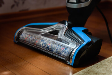 Modern vacuum cordless vacuum cleaner with water nozzle for cleaning floors. House cleaning.