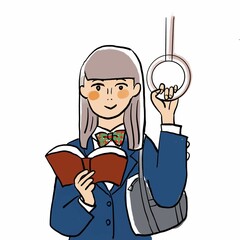 電車内で読書する学生　