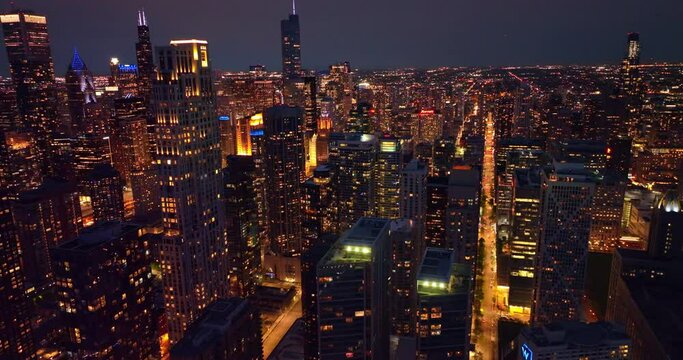 Lights of splendid Chicago at night time. Fascinating metropolis panorama from aerial perspective.