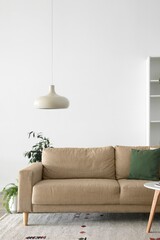 Sofa near light wall in living room