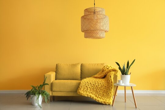 Sofa And Table Near Yellow Wall In Living Room