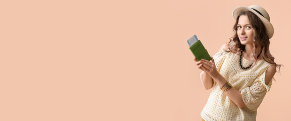 Beautiful female tourist holding passport and tickets on beige background with space for text