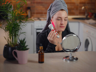 Young woman use Ultrasonic Skin Scrubber Exfoliating Wand. Skin care and age cosmetics concept....