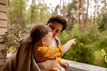 Happy grandmother and grandson enjoy time together. Positive middle age woman spending time with little, cute grandchild, having fun. 50-year-old grandma with grandkid. Multi-generational family.