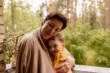 Happy grandmother and grandson enjoy time together. Positive middle age woman spending time with...