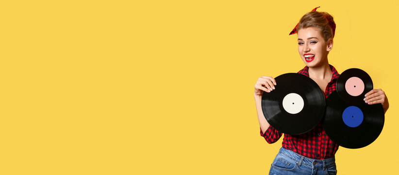 Beautiful pin-up woman with vinyl discs on yellow background with space for text