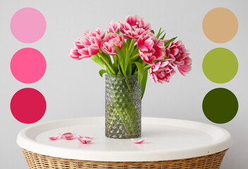 Vase with tulips on table near light wall. Different color patterns