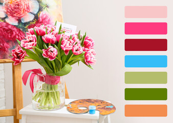 Bouquet of tulips with greeting card and paint palette on stool. Different color patterns