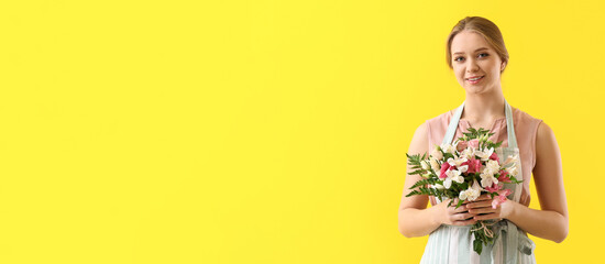 Young female florist holding bouquet of flowers on yellow background with space for text