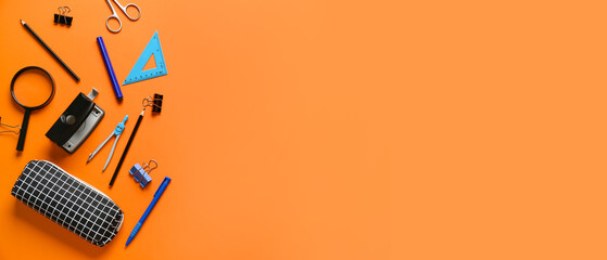 Pencil case and stationery on orange background with space for text